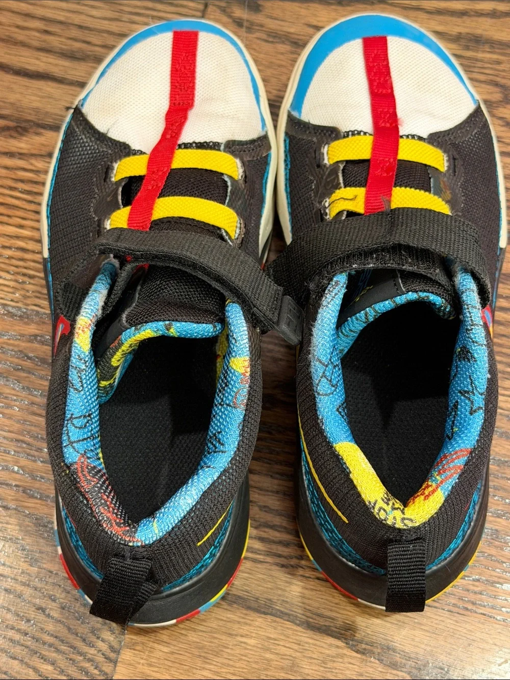 Nike Kids Black Sneakers with Blue, Red and Yellow Accents